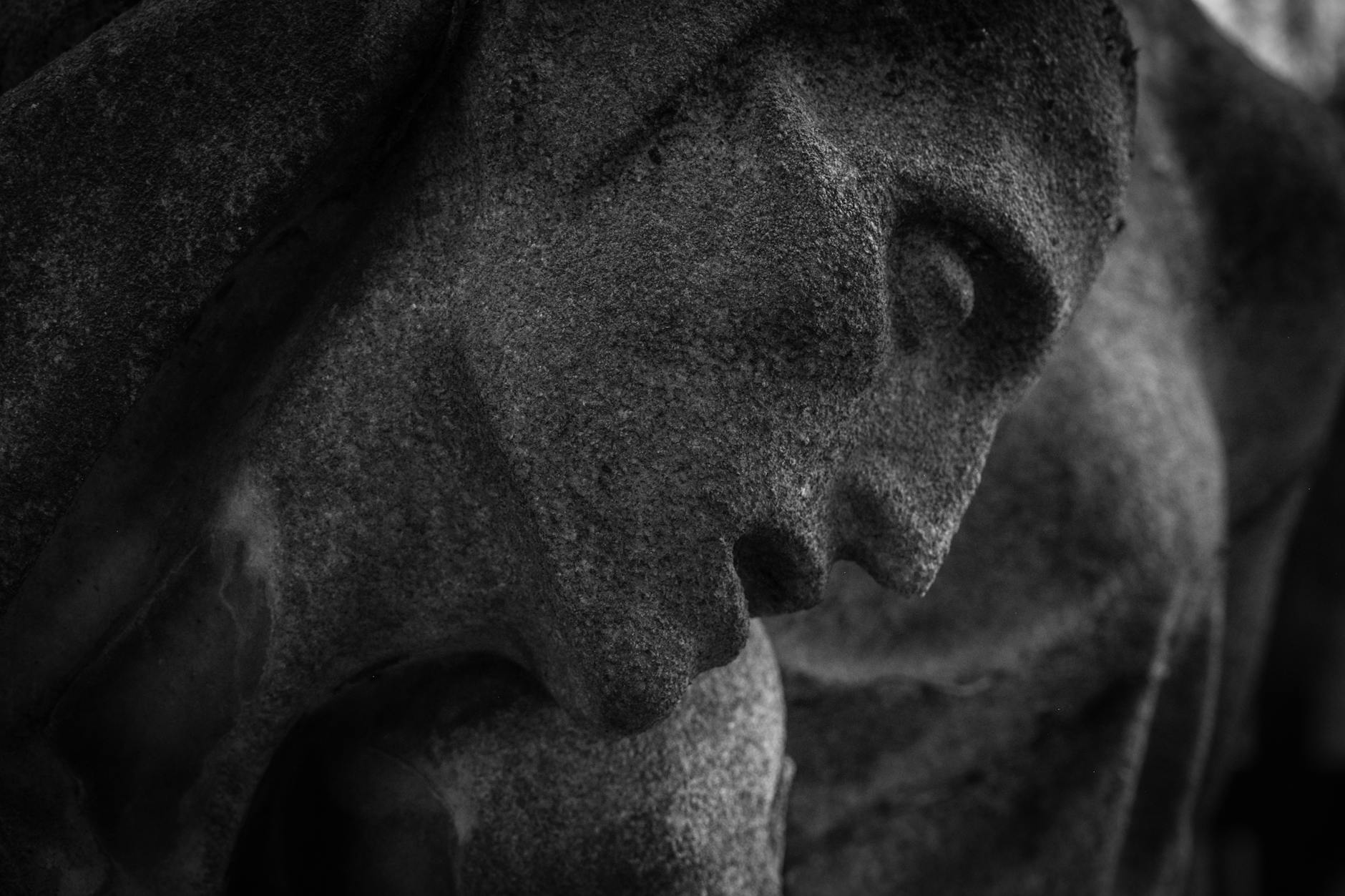 dramatic close up of stone sculpture in black and white